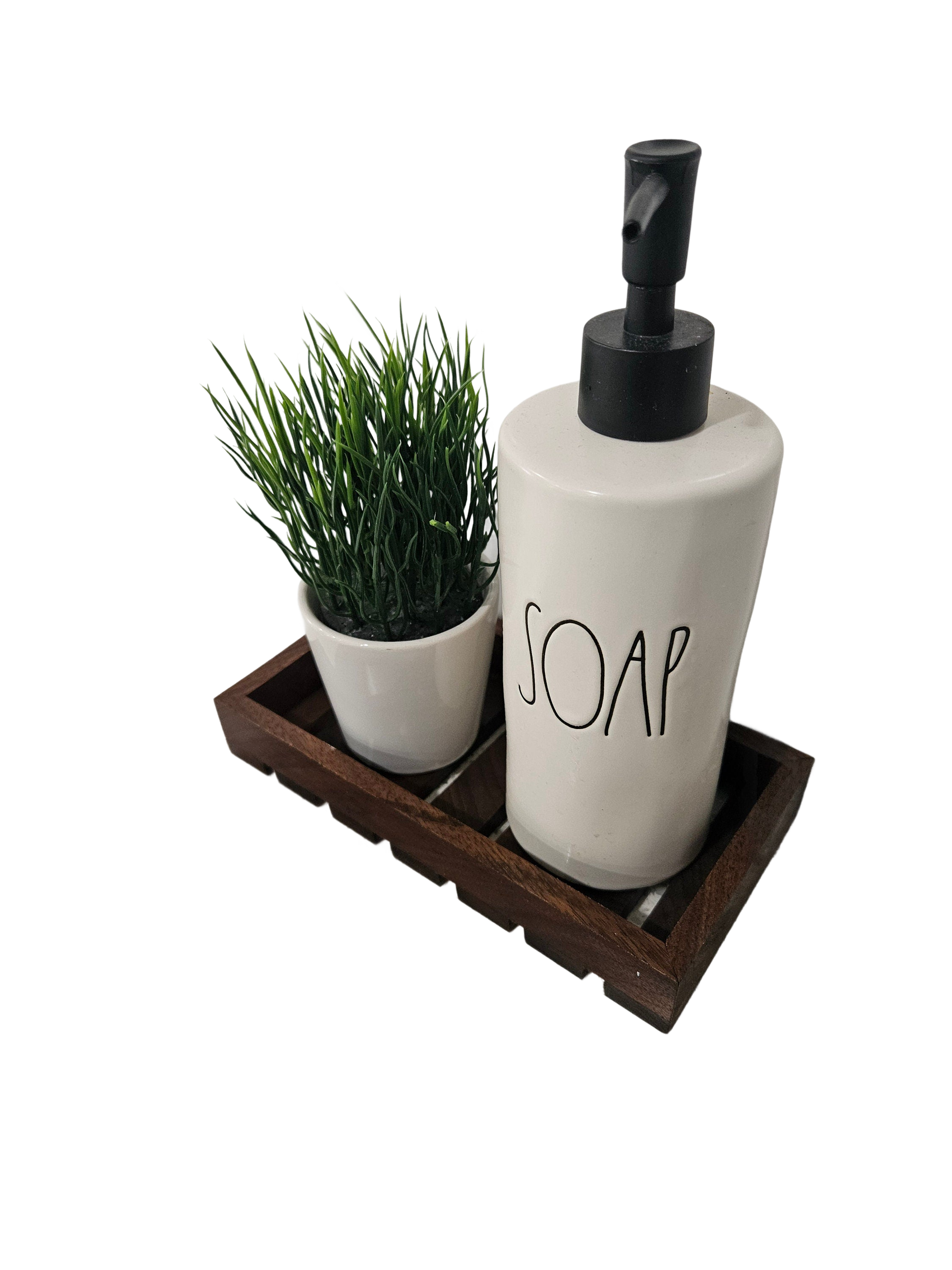 a soap dispenser and a potted plant on a tray
